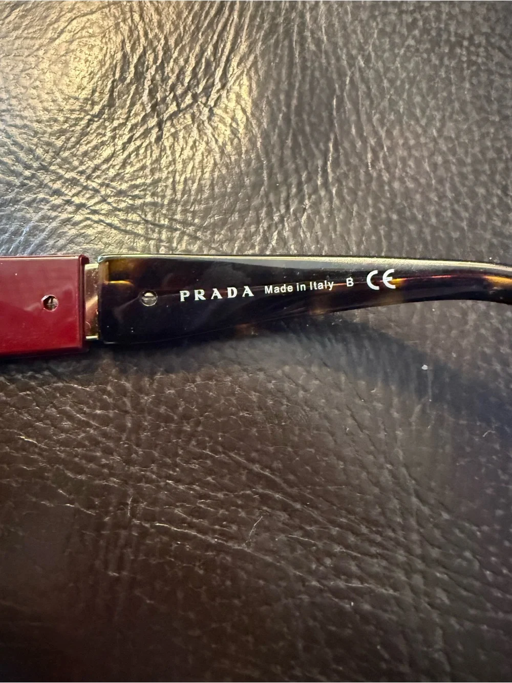 Prada Women’s Burgundy Cat-Eye Sunglasses with Dark Lenses
